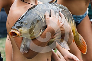 Children caught a huge carp fishing and keep it