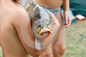 Children caught a huge carp fishing and keep it