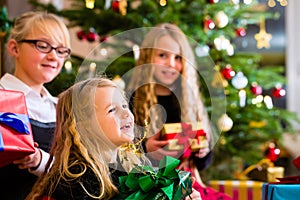 Children with Christmas gifts on Christmas day