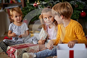 Children  with Christmas presents. kids open present