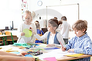 Children in the classroom painting pictures during art classes photo