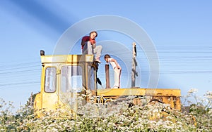 Children climb on the tractor CHTZ-URALTRAK T-130. A Soviet agricultural and industrial tracked tractor