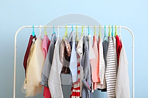 Children clothes on a hanger on a colored background.