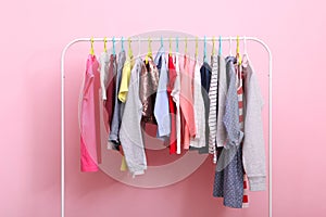 Children clothes on a hanger on a colored background.