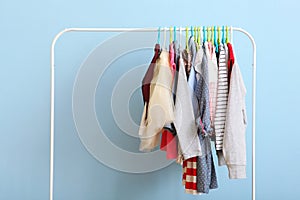 Children clothes on a hanger on a colored background.