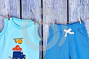 Children clothes hanging on rope.