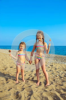 Children with colorful lollipops enjoy a summer vacation