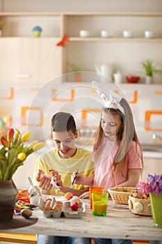 Children coloring Easter eggs