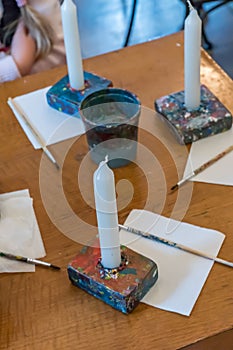 Children colorize a candles with acrylic paints