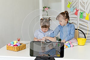 children conduct an online master class on decorating Easter eggs.