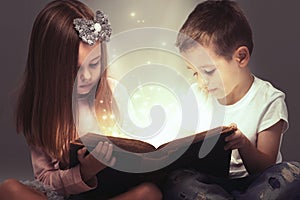 Children couple opened a magic book