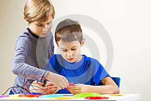 Children creating with 3d printing pen