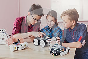 Stem education. Kids creating robots at school photo