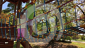 Children cross bridge on playground