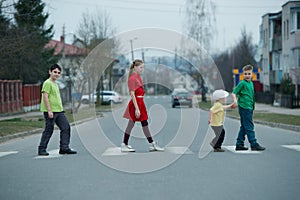 Children crossing street on crosswalk