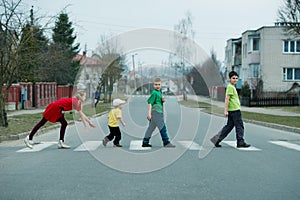 Children crossing street on crosswalk