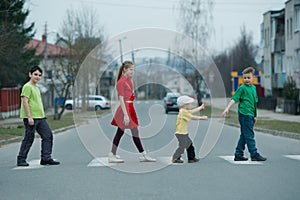 Children crossing street on crosswalk