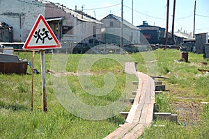 Children crossing warning road sign at rural area