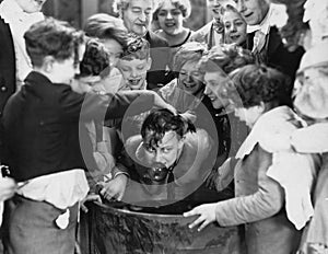 Children crowded around apple bobbing