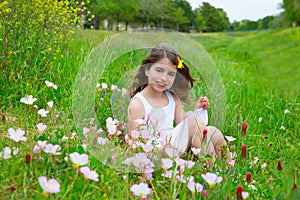 Children cute girl on spring meadow with poppy flowers