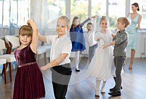 Children dance in pairs at festive matinee