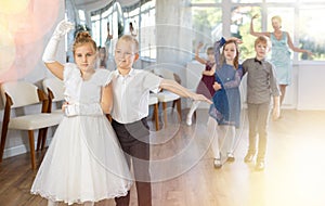Children dance in pairs at festive matinee