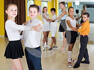 Children dancing pair dance in class