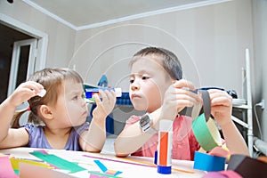 Children development - brother and sister making craft