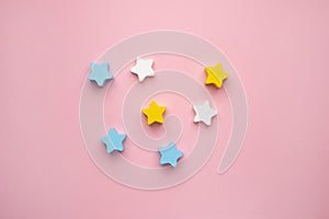 Children developmental toy for the development of motor skills, a crescent wooden stars balancer, on a pink background