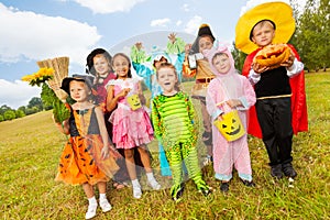 Children in different Halloween costumes standing