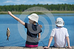 Children on the dock with fish