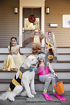 Children And Dog In Halloween Costumes For Trick Or Treating