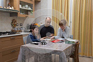 Children doing Homework: Studying in the Kitchen with Dad at Home