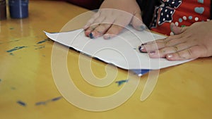 Children draw in kindergarten on paper