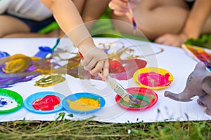 Children draw in summer park