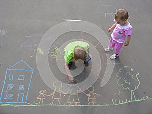 Children drawing on asphalt