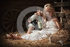 Children drink milk in the barn