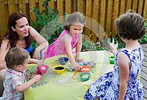 Children Dyeing Easter Eggs Outside