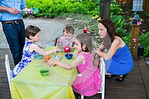 Children Dyeing their Easter Eggs Outside