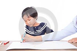 Children earnestly study drawing lessons under the guidance of the teacher