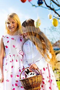 Children on Easter egg hunt with bunny