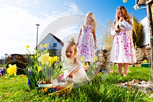 Children on Easter egg hunt with bunny