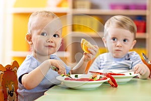Children eat healthy food in nursery or creche
