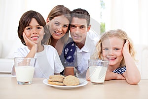 Children eating biscuits and drinking milk