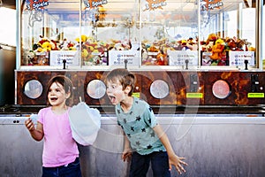 Children eating cotton candy at the carnival