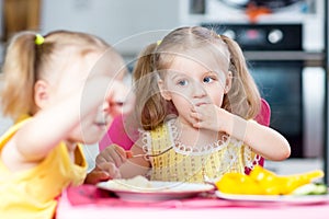 Children eating in kindergarten or at home