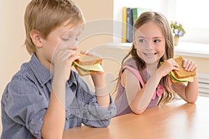 Children eating sandwiches.
