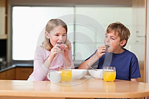 Children eating strawberries for breakfast
