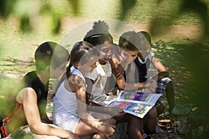 Children and education, kids and girls reading book in park photo