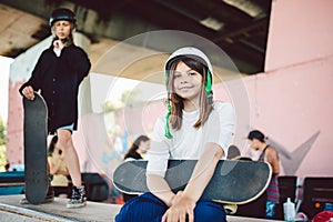 Children education, sports. Teenage girl in skateboard park. Youth, health, safety, sport concept. Beautiful kid female